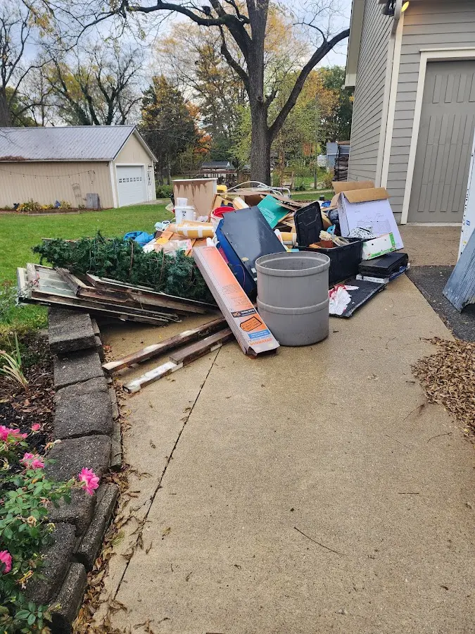 Dumpster being loaded with debris for Roofing Dumpster Rental in Pohatcong